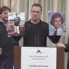 The suits were filed by Stephen Tyminski, now a 66-year-old Orthodox priest in Queens, and Keith Mozian, 56, of Califon. Stephen Marlowe, 48, holds photos of and speaks on behalf of Mozian, who couldn't be at the conference.