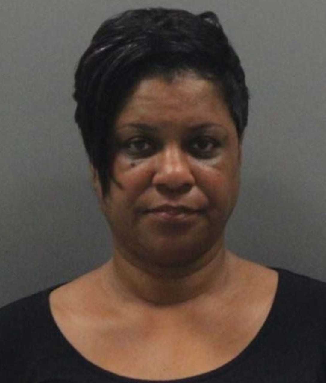 Shakela Holley has been arrested for helping the suspect in a double-homicide investigation stay on the run.