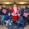 Teaneck Fire Department Firefighter Union members from FMBA 42 & 242 meet Santa Claus in the Holy Name Hospital lobby.