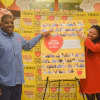 Tuckahoe ShopRite associates Michael Cabazas and Natasha Smith, who are both from Yonkers, point to their photos that appear on a special edition Cheerios box sold exclusively in ShopRite stores this month.