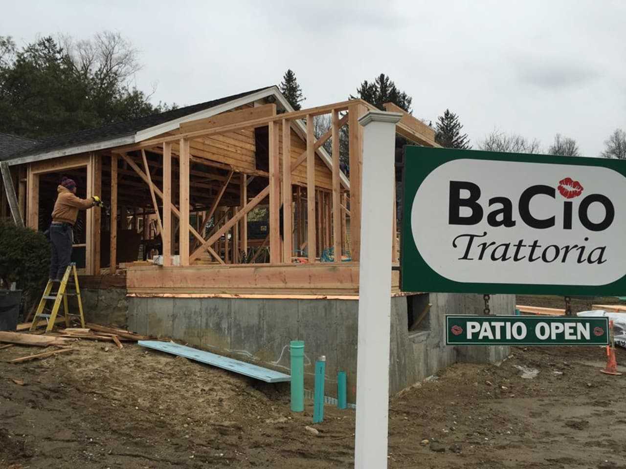 Construction workers rebuild Bacio Trattoria earlier this year. The restaurant re-opened in late May and has nearly doubled its seating capacity.