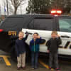 The winners of the Barnum Ball auction rode to school in a police car.