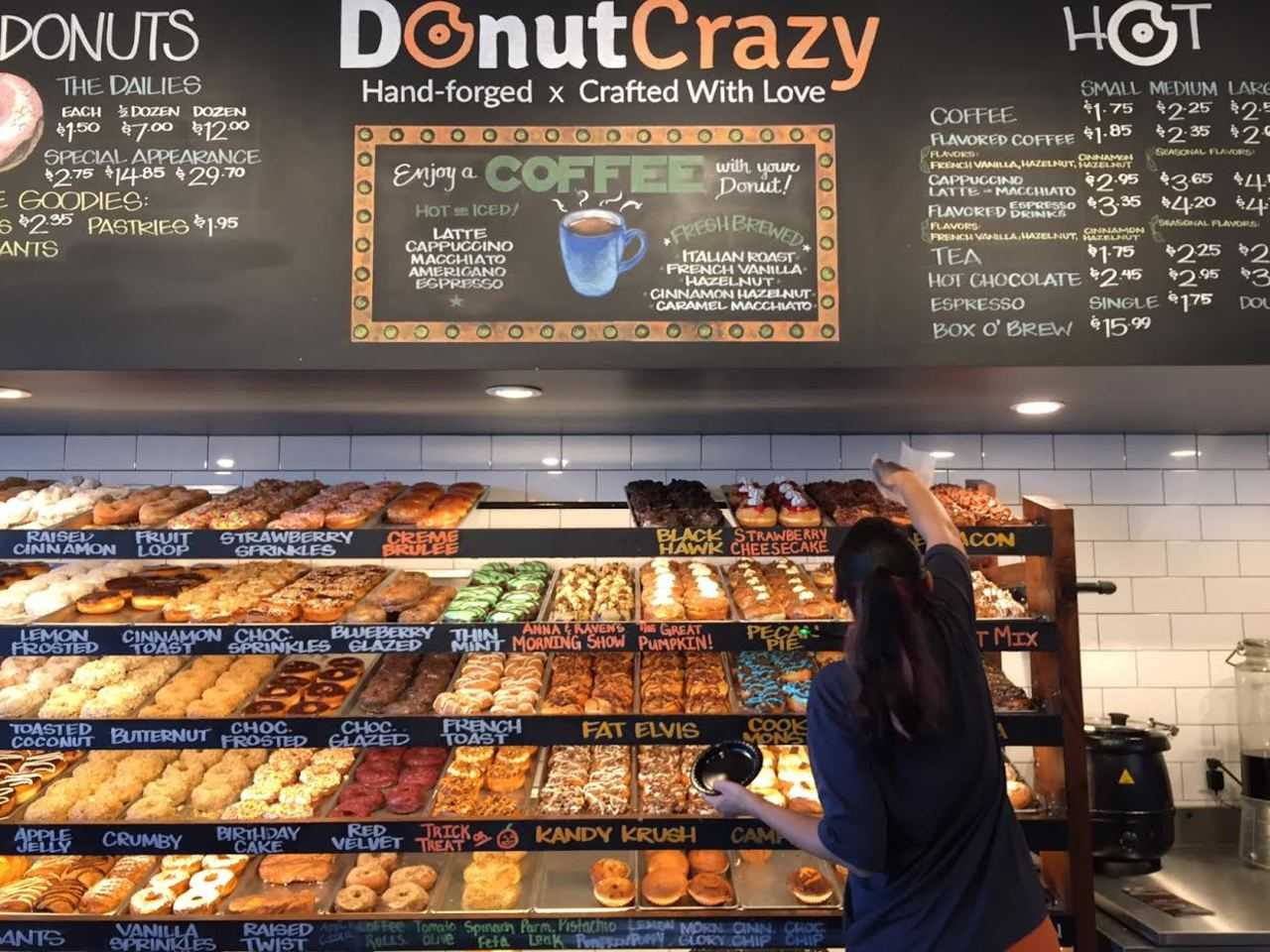 Nicole Smith reaches for a customer favorite at Donut Crazy in Shelton. 