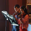 Violinists take the stage during Monday's Flag Day ceremony at Daniel Webster Elementary School.