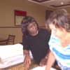 Christine Francis of YAI works with a YAI woman at the DoubleTree hotel in Tarrytown.