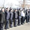 Members of the Norwalk Police Department, joined by former chief and current Mayor Harry Rilling, salute retired Lt. Tim Murphy after his Mass of Christian Burial on Saturday at St. Aloysius Church in New Canaan.