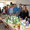 Central Hudson employees shown with donations to the company's 35th annual food drive.