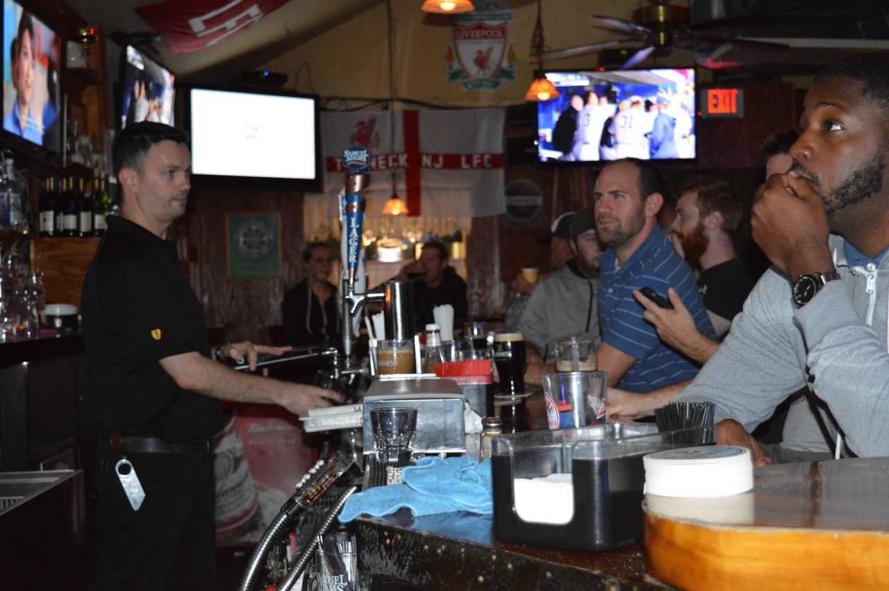 Bartender and owner of The Cottage Bar, Mickey Dawson, pours a tall glass of beer for a customer at his Teaneck watering hole.
