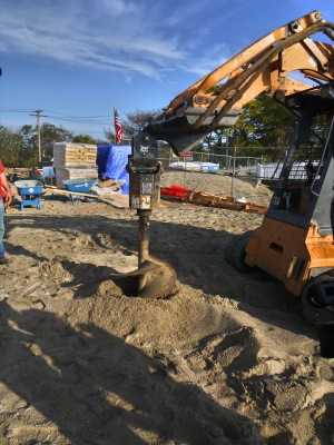 Travis Rekos, the brother of Sandy Hook victim Jessica, helped to start digging the new playground at Fairfield's Penfield Beach Friday morning. 
