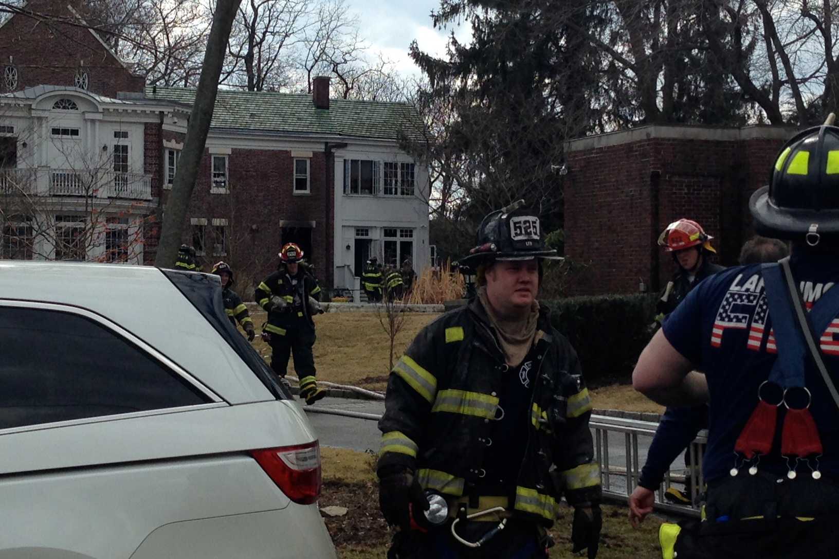 Fire crews battle a fire in a home in Larchmont on Thursday.