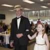 From left: Gene Ceccarelli from Port Chester with 11-year-old Annie Christensen from Rye take the catwalk at Greenwich Hospital's fashion show to honor its volunteers. 