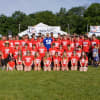 The New Canaan football team with Mark Herzlich of the New York Giants.