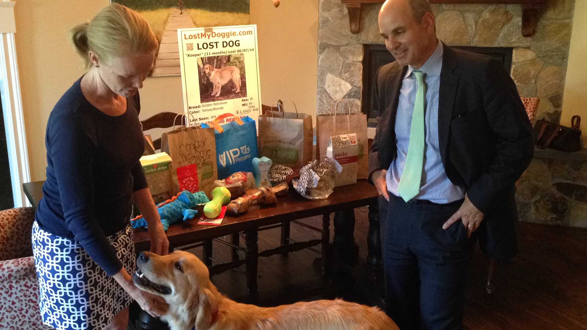 Katy and Keith Pagnani show Kooper all the goodies people have sent him, like food and toys, since he returned home Sunday. 