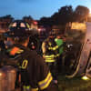 Fairfield firefighters examine the rolled over FedEx tractor-trailer as the sun begins to rise. 