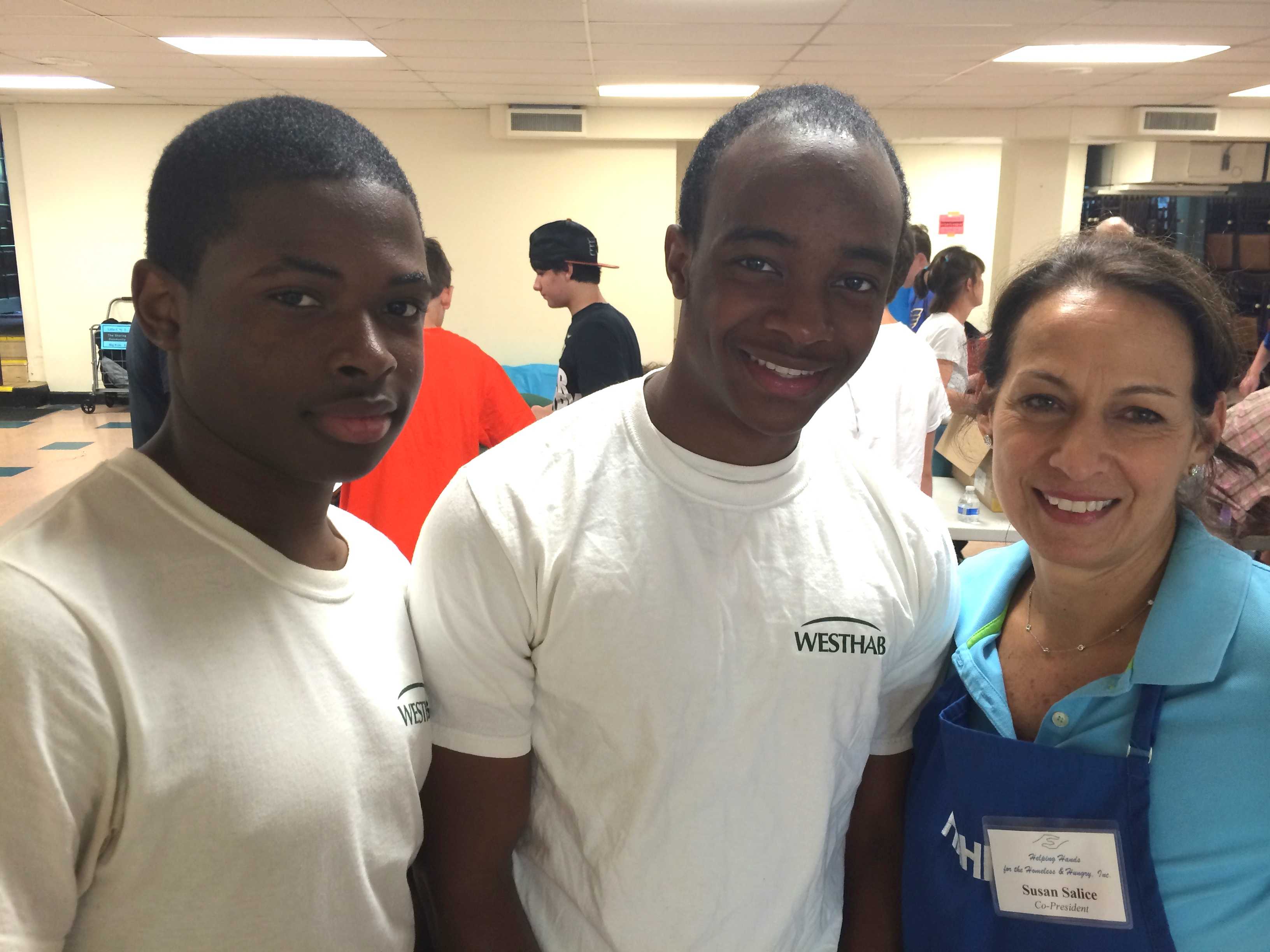 <p>Mount Vernon residents Aashawn Barnes, left, and Kojo Gordon, center. are WestHab volunteers. </p>