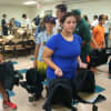 Jacmine Arteaga, of Port Chester, helps fill backpacks. 