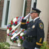 New Canaan Police Capt. Vincent DiMaio, salutes during the New Canaan 9/11 ceremony. 