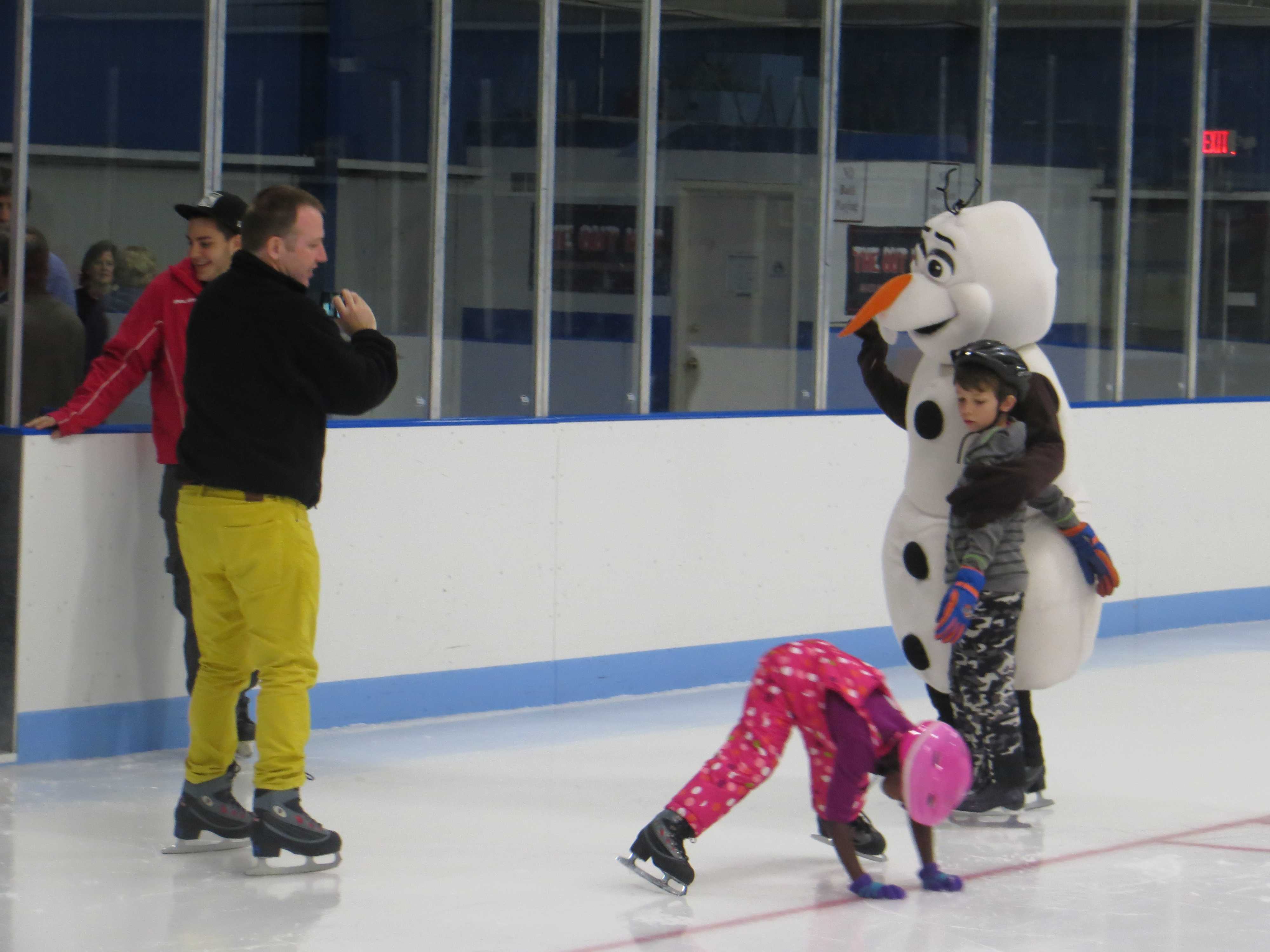 Children taking falls, and photos, near Olaf the snowman.