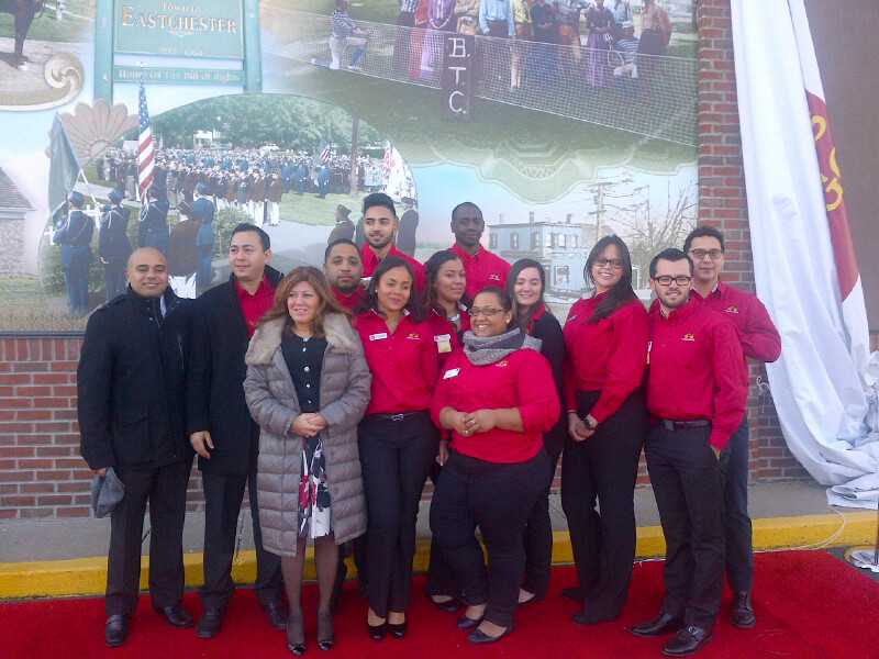 Members of the Wells Fargo team in front of the Eastchester historical mural.