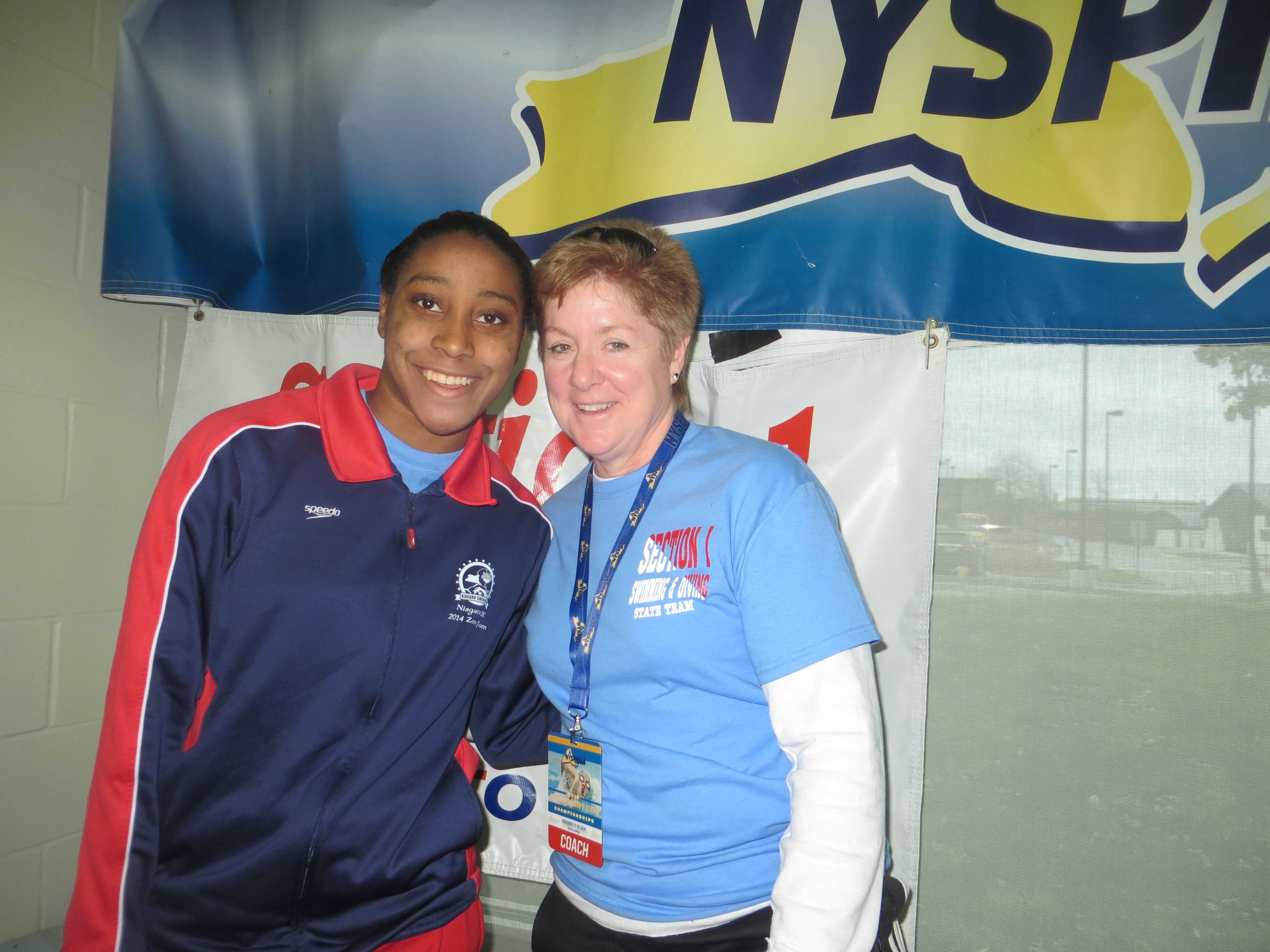 Nicole Parry with Mamaroneck swim coach Cathleen Ferguson after her relay race and before her individual sprint races.