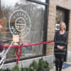 Larchmont Mayor Anne McAndrews, left, cuts the ribbon Tuesday outside the village's newest business at  28 Chatsworth Ave.
