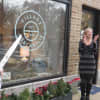 Vonnie Sullivan, right, reacts to the official grand opening of Village Mercantile on Tuesday.