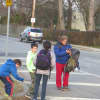 <p>An adult waits for three children from Osborn Elementary School on Thursday and then crosses Boston Post Road to Sonn Drive.</p>