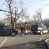 <p>Another adult crossing Boston Post Road with a child, between stop-and-go traffic, shortly after 3 p.m.</p>