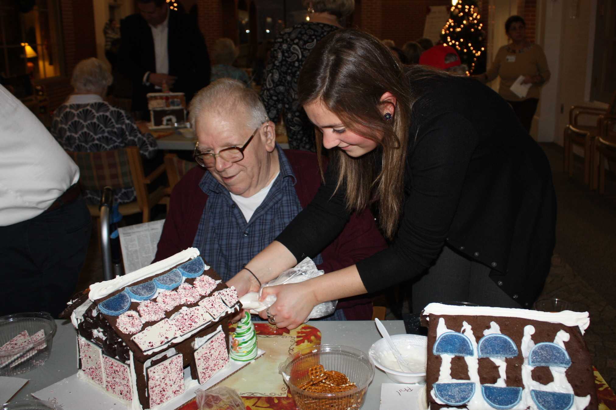 A volunteer from UBS helps a gentleman at Waveny LifeCare Network in New Canaan.