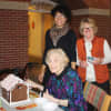 UBS volunteers celebrate the successful completion of a gingerbread house at Waveny LifeCare Network in New Canaan.
