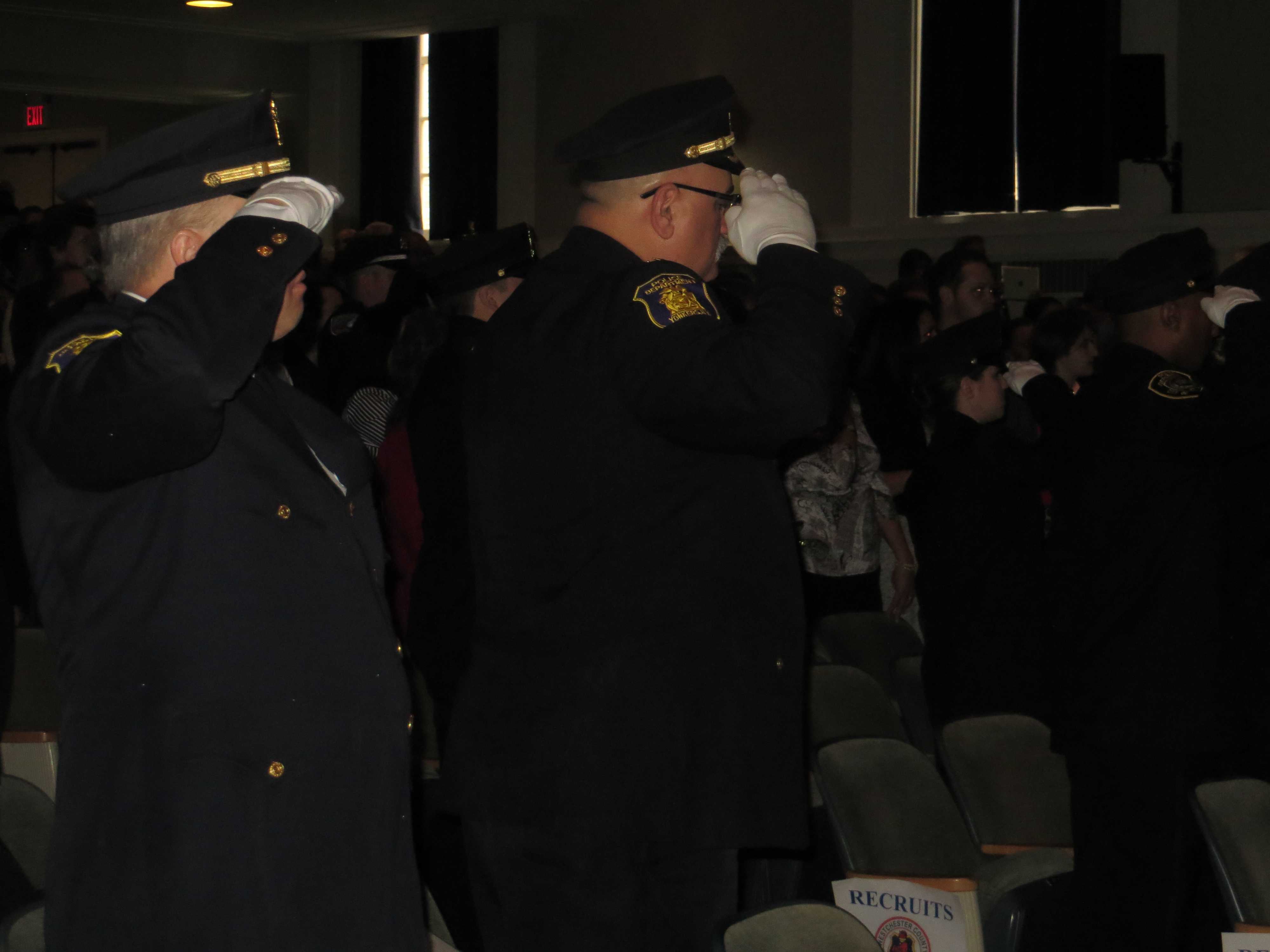 Police Academy graduates salute during the national anthem sung by officers from Hastings-On-Hudson and Yonkers.