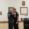 Elmsford Police Commissioner Frank Rescigno pinned his 30-year-old badge on his son, Paul, the village's newest patrol officer.