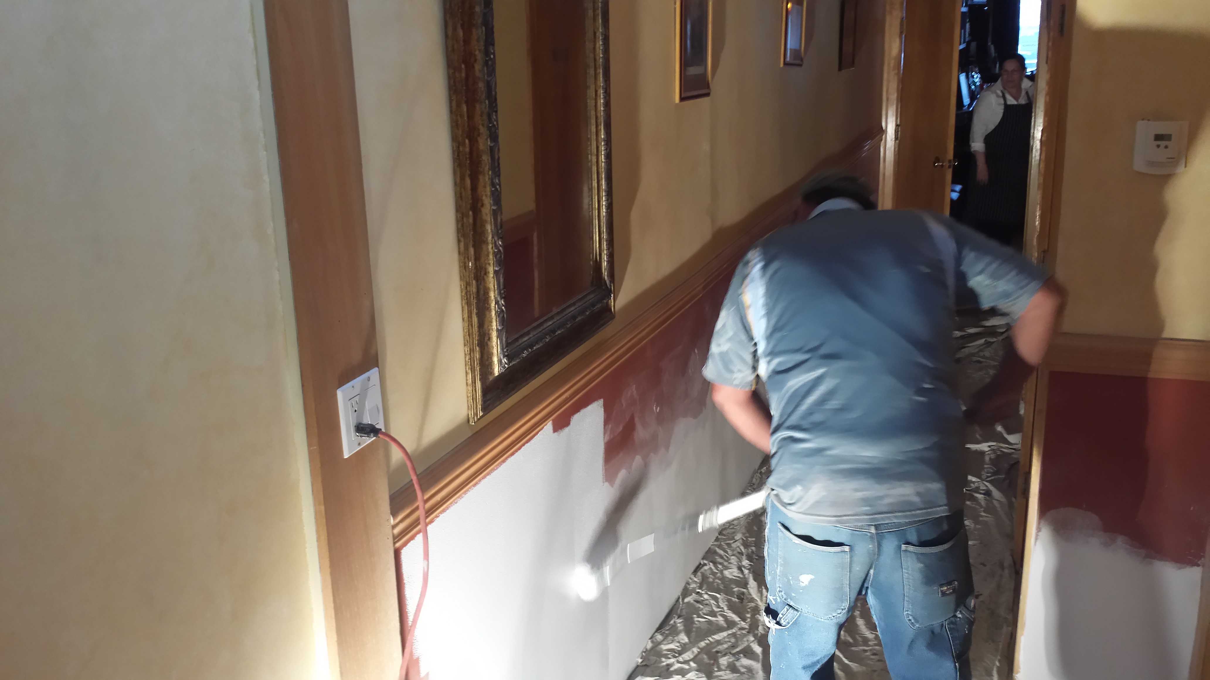 Crews continue to put finishing touches on hallways and "the fireplace room" at the flood-damaged restaurant.