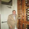 Andrew Economos in front of his wine cabinet at the Iron Horse Pleasantville.