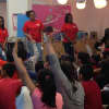 Brookside Elementary students in Norwalk raise their hands in a talk with students from HEART.