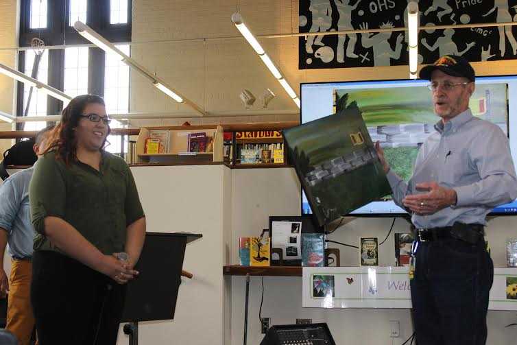 An Ossining High School student presents artwork to honor war veterans. 