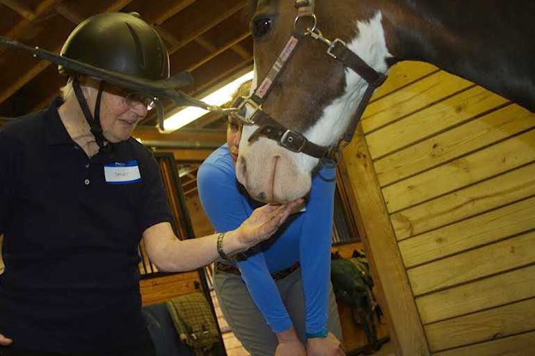 Hannah Wirfel, a PATH Therapeutic Riding Instructor, works with Janet, a resident of Waveny LifeCare Network in New Canaan.