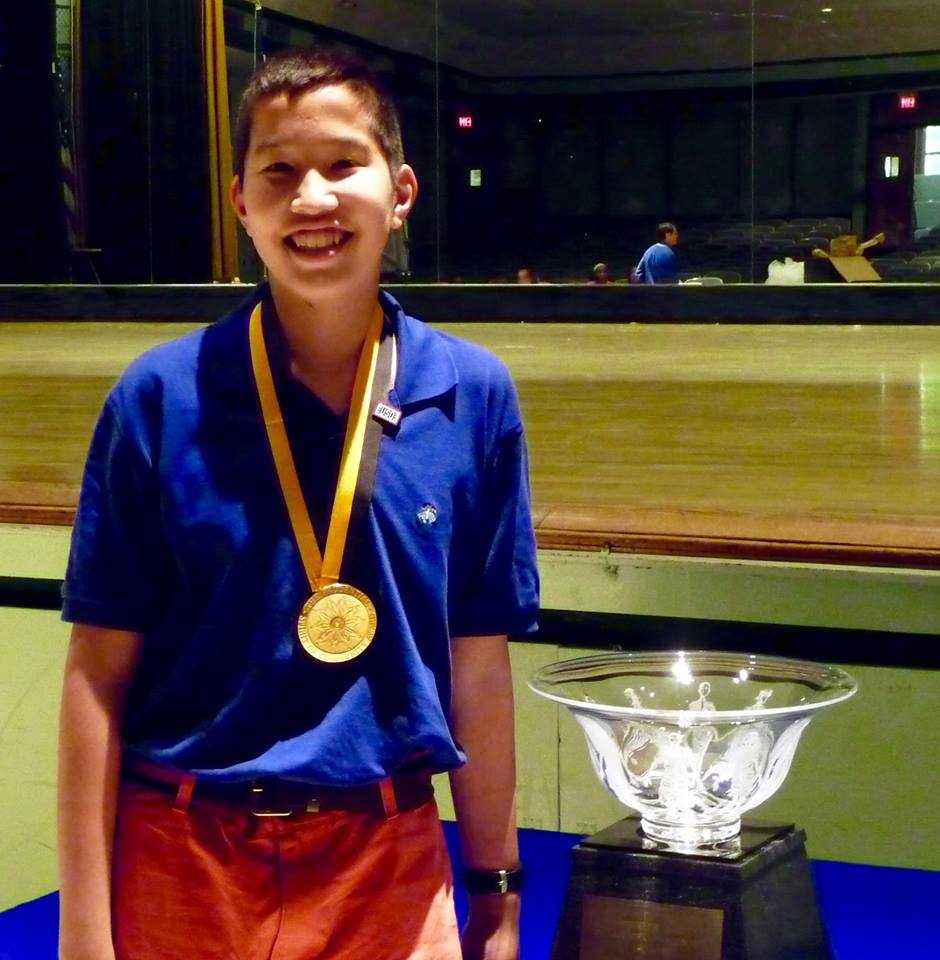 New Rochelle middle school student Jake Gallin with the trophy celebrating his volunteer work.