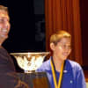New Rochelle Middle School student Jake Gallin being awarded his trophy for his volunteer work.