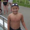 <p>A swimmer smiles for a photo before getting cool in the pool.</p>