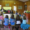 A group of young Eastchester Girl Scouts listens intently during the presentation on bullying.