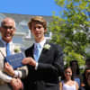 Carter Alvord of New Canaan who attended New Canaan Country School from Pre-K through Grade 9, receives his certificate of graduation from Head of School Dr. Robert Macrae.