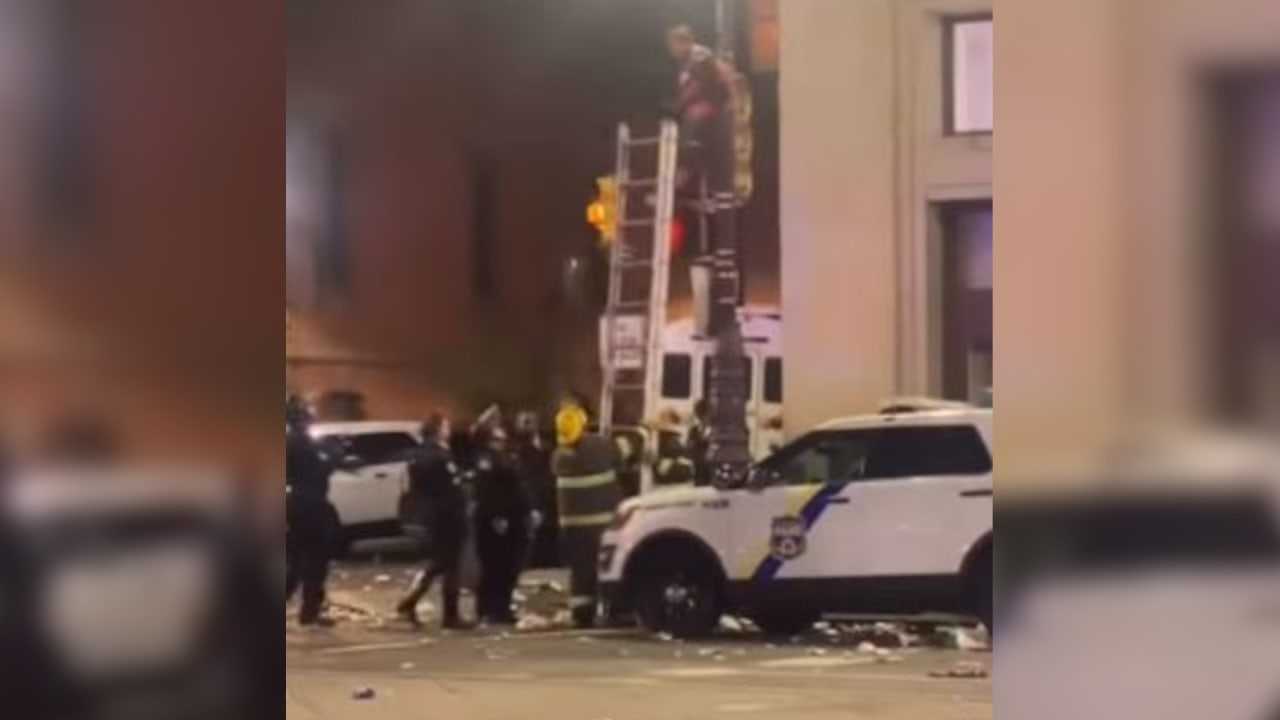 Triumphant Phillies Fan Climbs Street Pole, Gets Stuck (VIDEO)