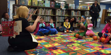 Denise Carrozza, children's librarian, leads story time at the Wanaque Public Library's Halloween party.