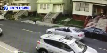 In this video still, someone with a gun is seen firing  at a Newark house through the back window of a car Wednesday. A young girl was wounded in the incident.
