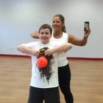 Tricia Serow Bazzano of Ringwood helps her son exercise.