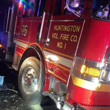 Two volunteer firefighters were injured in a crash that disabled one of the station's engines, station officials said.