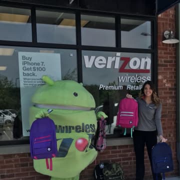 Brewster Verizon Wireless Zone store manager, Katie Kaslyn, pictured with backpack giveaways