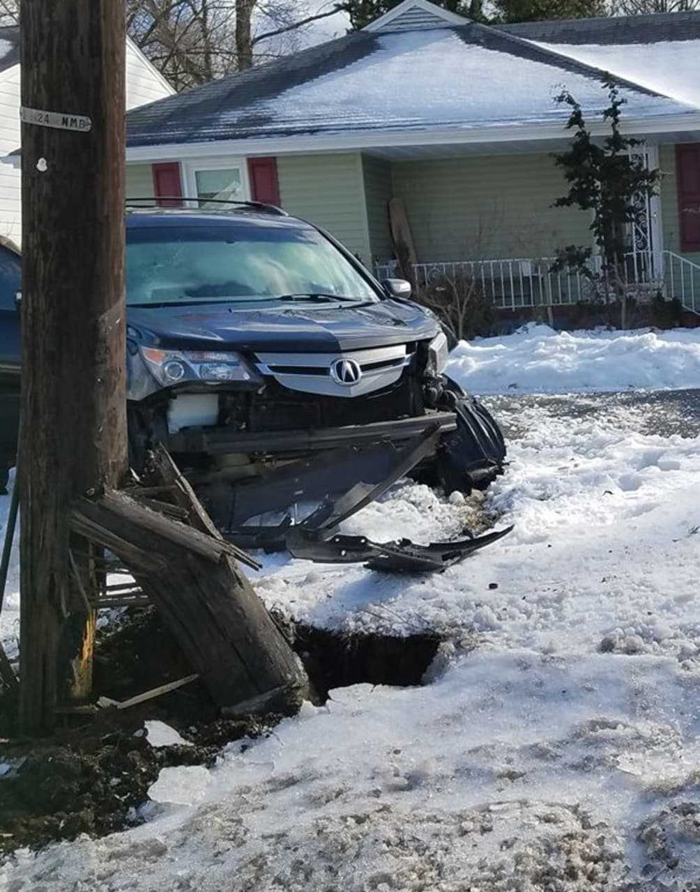 The pole, held by wires, swayed slightly over the roadway.
