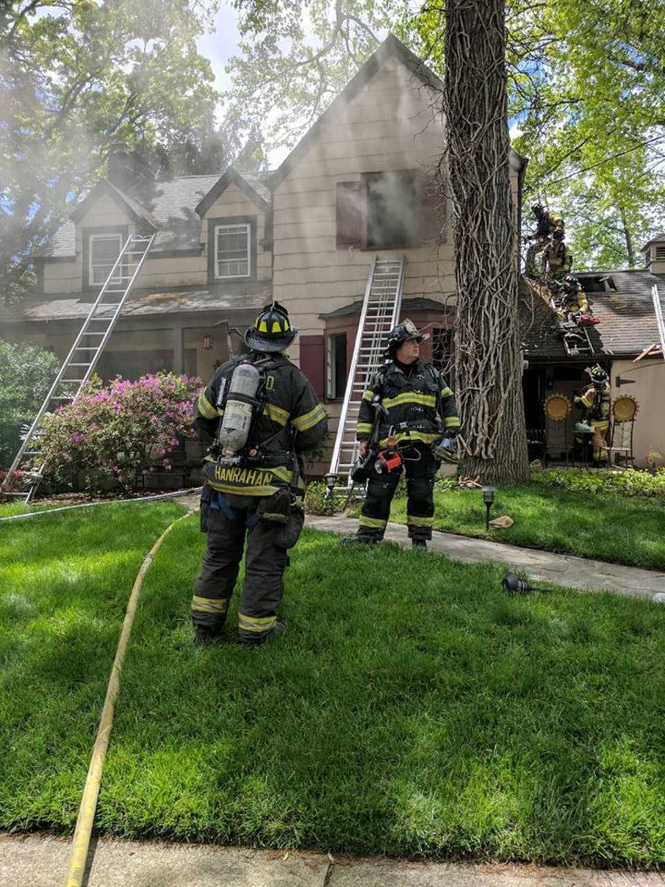 Hackensack firefighters work a Teaneck blaze Monday.